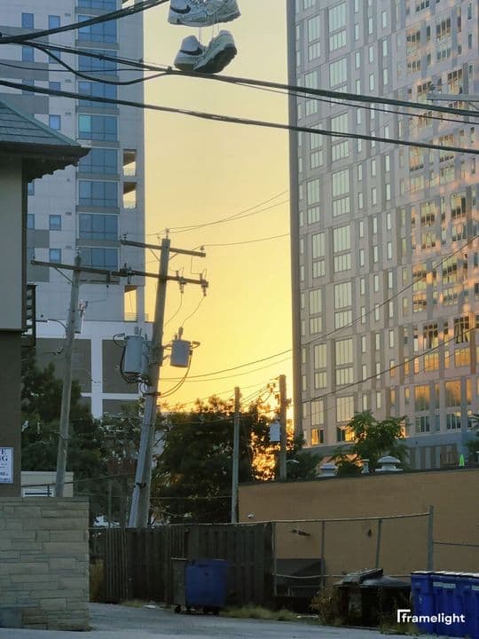 Sneakers hanging from a wire at golden hour